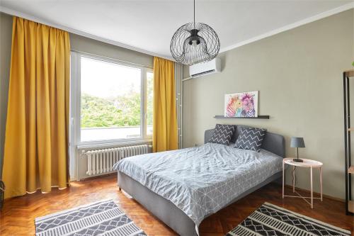 a bedroom with a bed and a large window at LAZUR ~ 2BD Flat next to the Sea Garden in Burgas City