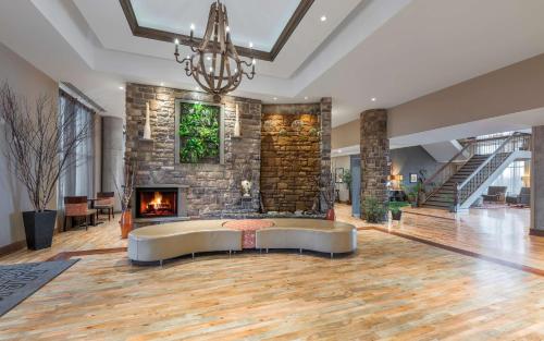 a living room with a couch and a fireplace at Hampton Inn Sydney in Sydney