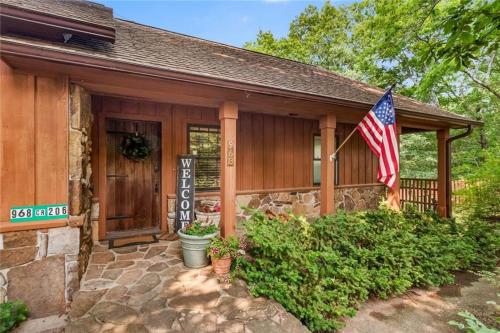 a house with a flag in front of it at White River Mountain Manor- Million dollar view in Eureka Springs