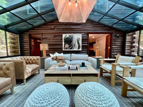 a living room with a couch and a table at Glass Cabin in Eureka Springs