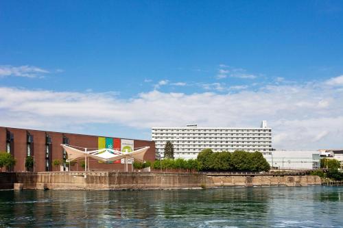 a building next to a body of water at DoubleTree by Hilton Hotel South Bend in South Bend