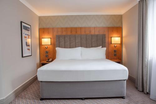 a large bed in a hotel room with two lamps at DoubleTree by Hilton Southampton in Southampton