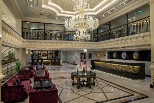 a large lobby with a chandelier and red furniture at DoubleTree By Hilton Gaziantep in Gaziantep