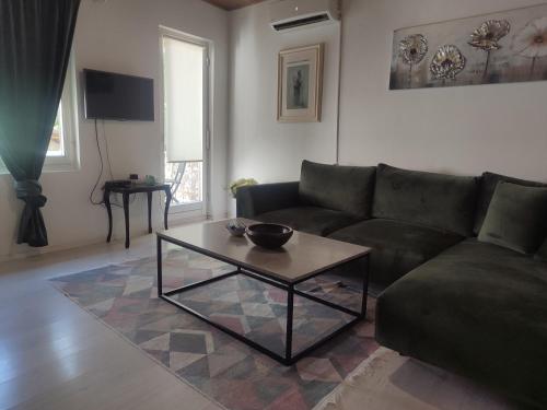 a living room with a couch and a coffee table at Apartment Mejdan in Mostar