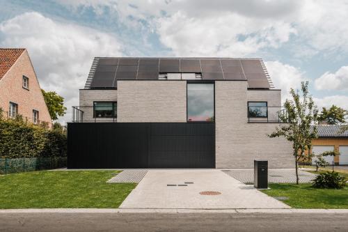 a house with a lot of solar panels on it at BEE n BEE in Bruges