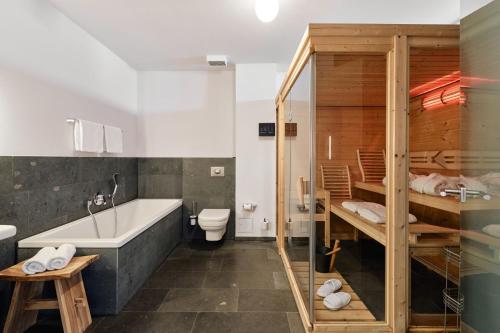 e bagno con vasca, servizi igienici e lavandino. di havelblau Ferienlofts a Brandenburg an der Havel