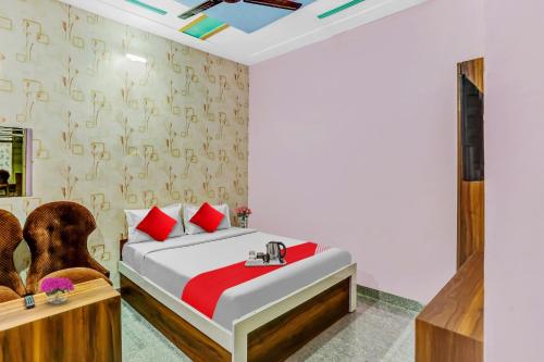 a bedroom with a bed and a chair at Hotel O K D Guest House in Manesar