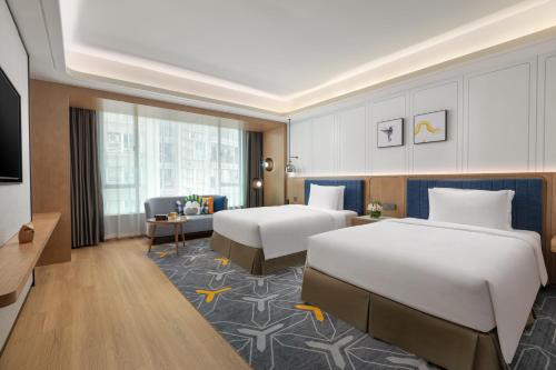 A bed or beds in a room at voco Guangzhou Shifu, an IHG Hotel