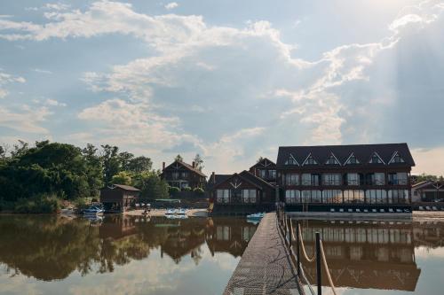 a bridge over a body of water with houses at Waterloo Village in Pidhorodne