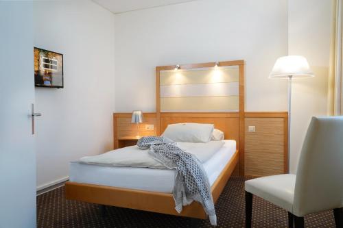 Una cama o camas en una habitación de Park-Hotel am Rhein - Gesundheitshotel und Residenzen