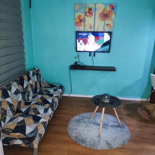 uma sala de estar com um sofá, uma mesa e uma televisão em Departamento Santiago Centro em Santiago