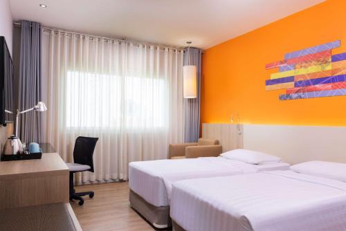 A bed or beds in a room at Park Inn by Radisson Davao