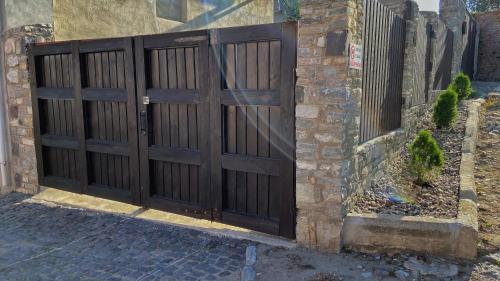 a wooden door on the side of a house at Квартира у Старому місті in Kamianets-Podilskyi