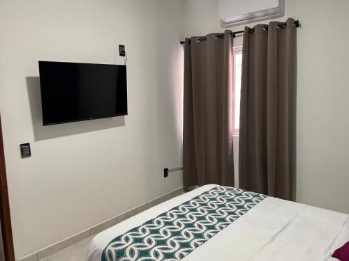 una camera con TV a schermo piatto e letto di Departamentos Madera a Tequila