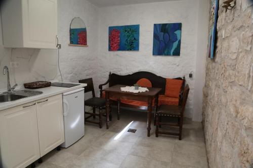 a kitchen with a table and some chairs and a table at Golubica in Stari Grad