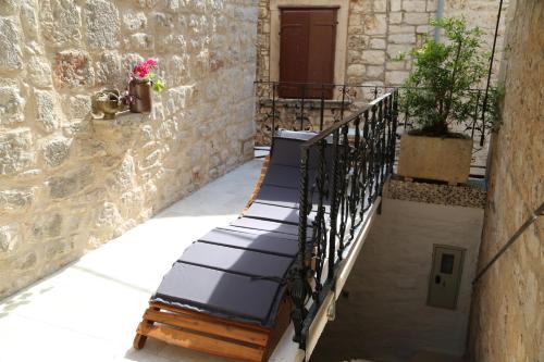 a row of benches sitting on a balcony at Golubica in Stari Grad