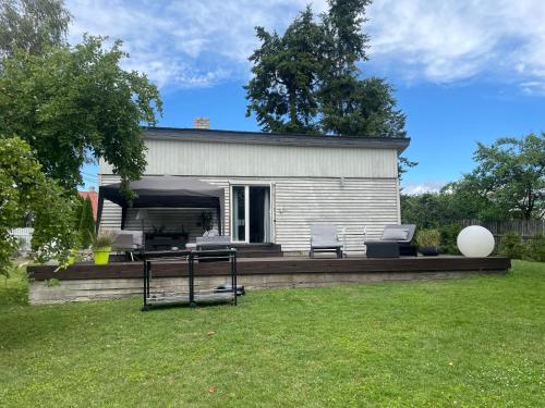 a house with a patio with two chairs and a table at Silja in Pärnu