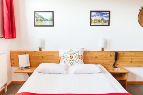 a bedroom with a white bed and two desks at Willa Jordanówka in Czorsztyn