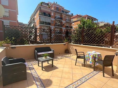 a patio with chairs and a table on a balcony at Pit stop Ciampino Station in Ciampino