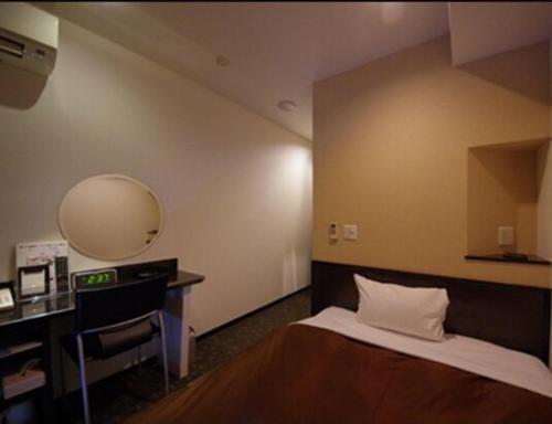 Tempat tidur dalam kamar di Urbain Hiroshima Executive