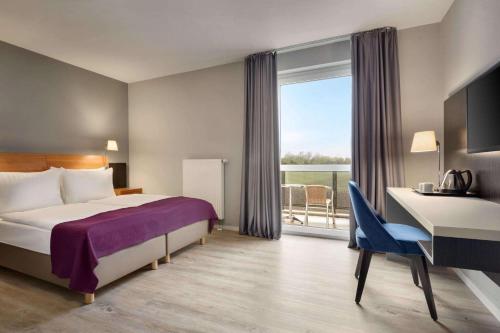 En eller flere senger på et rom på Ramada by Wyndham München Airport