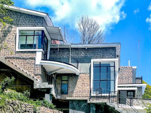 a brick building with a spiral staircase on it at LOKAL Rooms x Murree Kashmir Point in Murree