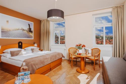 een hotelkamer met een bed en een tafel bij Hotel Merkur - Czech Leading Hotels in Praag