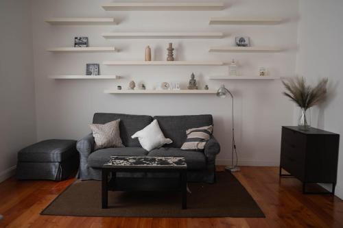 a living room with a gray couch and a table at Domus Montebello in Rome