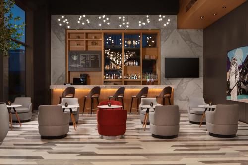 een lobby met een bar met stoelen en een tv bij Four Points by Sheraton Istanbul Kagithane in Istanbul