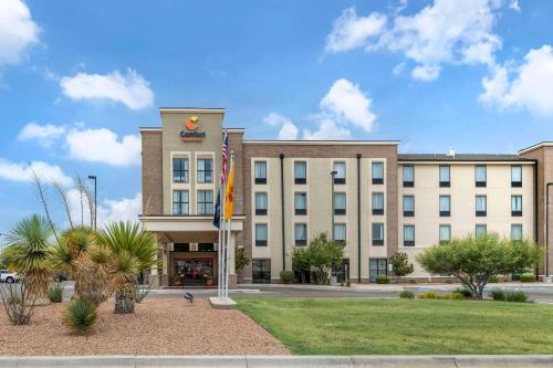 un bâtiment doté d'un drapeau devant lui dans l'établissement Comfort Suites Carlsbad, à Carlsbad