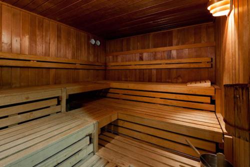 a large empty sauna with wooden benches in a room at Sporthotel Malchow Hotel Garni HP ist möglich in Malchow