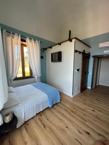 a bedroom with a bed and a large window at Villa Mazza al Vesuvio in Torre del Greco