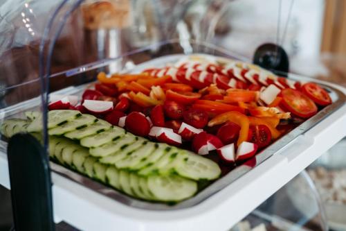 a tray of vegetables on a plate on a shelf at Bed & Breakfast Landhaus Strasser in Söll