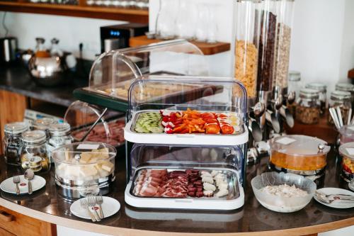 a counter with two trays of different types of vegetables at Bed & Breakfast Landhaus Strasser in Söll