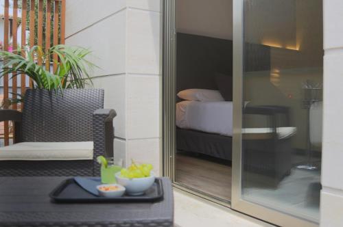 a view of a room with a bed and a table at Hotel Sitges in Sitges