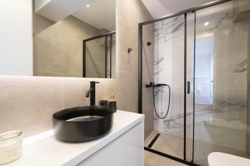 a bathroom with a black sink and a shower at Luxury 4 Bedrooms Apartment Near Flisvos Marina in Piraeus