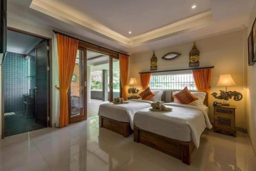 Кровать или кровати в номере Gefecon Villa Ubud