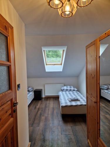 a bedroom with two beds and a window at Gościniec Błogocice in Cieszyn