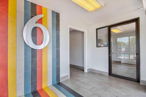 a building with a colorful wall with a sign on it at Motel 6 Jonesboro in Jonesboro