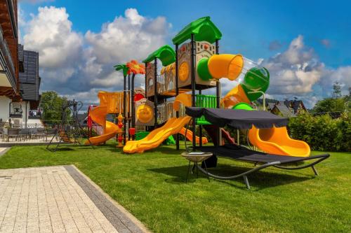 a park with a playground with a slide at Hotel Bystra in Białka Tatrzanska