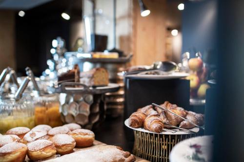 a display of pastries and breads in a bakery at Hotel Acadia - Adults Mountain Home in Selva di Val Gardena