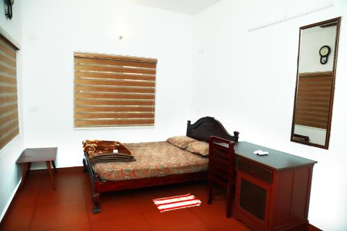 מיטה או מיטות בחדר ב-Back Packers Cochin Villa