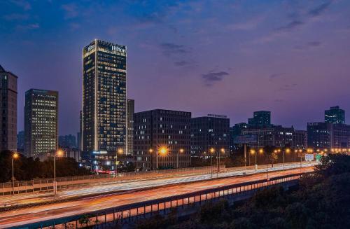 un skyline di notte con un edificio alto di Hilton Chongqing Liangjiang New Area a Chongqing