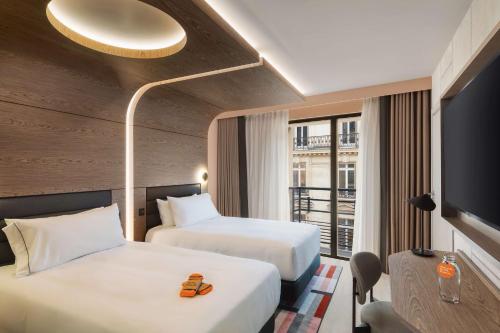 En eller flere senger på et rom på Canopy By Hilton Paris Trocadero