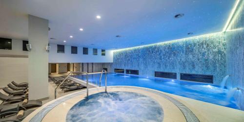 a large swimming pool in a building at Hilton Podgorica Crna Gora in Podgorica