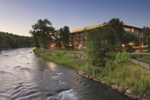 une rivière en face d'un bâtiment à côté d'un bâtiment dans l'établissement DoubleTree by Hilton Durango, à Durango