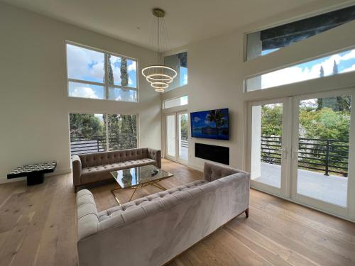 ein Wohnzimmer mit einem Sofa und einem Tisch in der Unterkunft Gorgeous New Private and Gated Home in Prime Silver Lake in Los Angeles