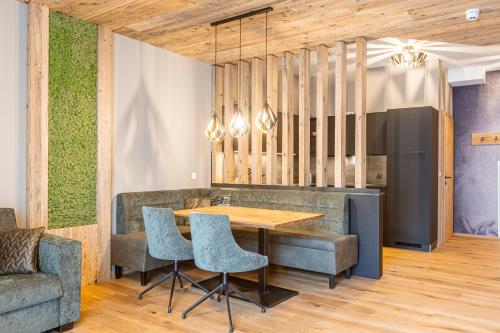 a dining room with a wooden table and chairs at Zillertal Suites Fügen by ALPS RESORTS in Fügen