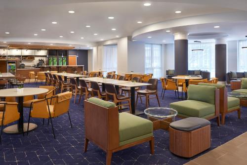 - un restaurant avec des tables et des chaises dans une salle dans l'établissement Courtyard by Marriott Toronto Markham, à Markham