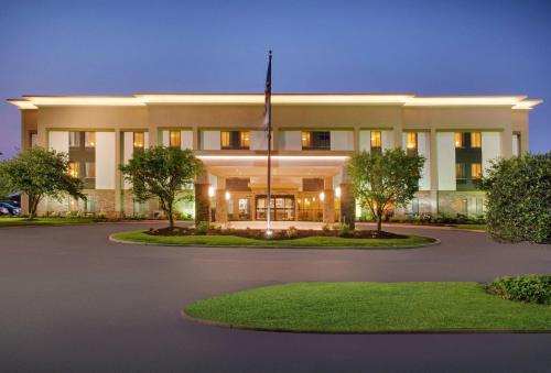 a building with a flag in front of it at Hampton Inn Merrillville in Merrillville